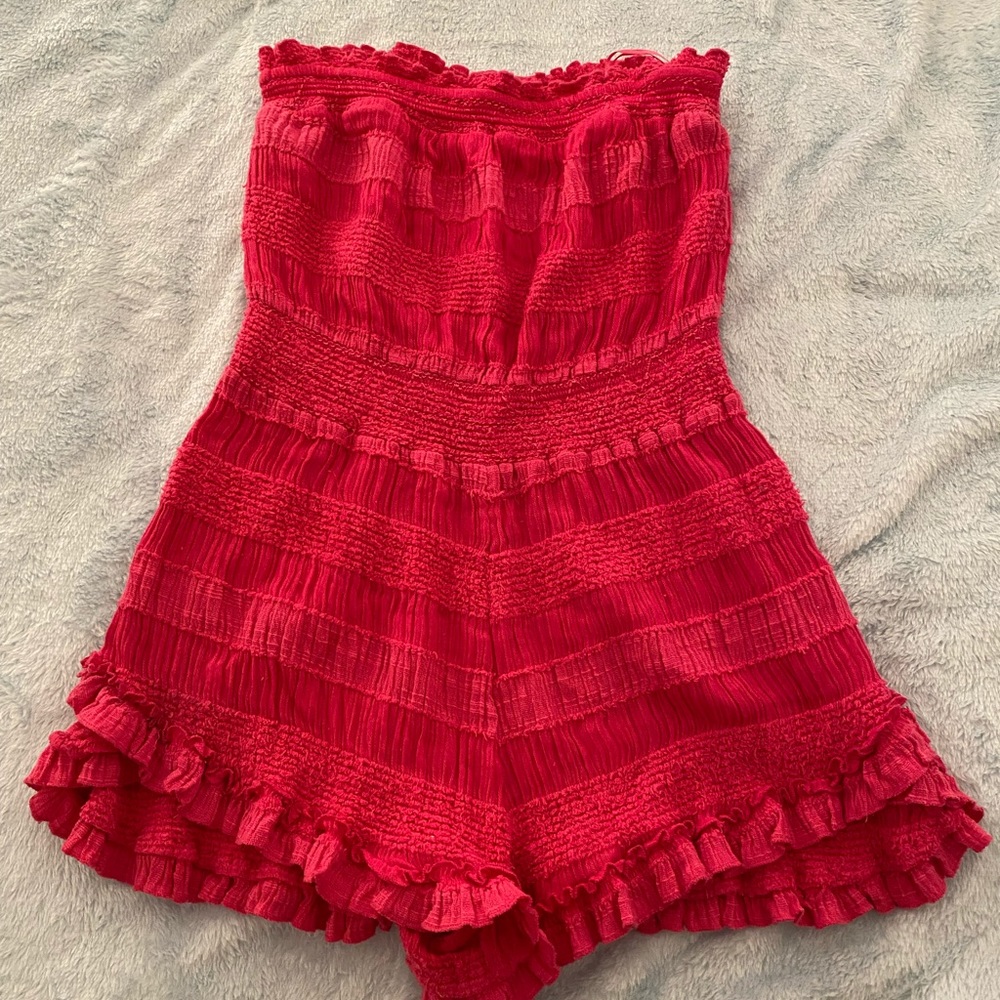 Pink strapless romper.
